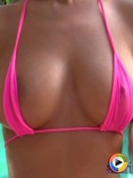 Barbies oil soaked bikini top barely covers her large breasts